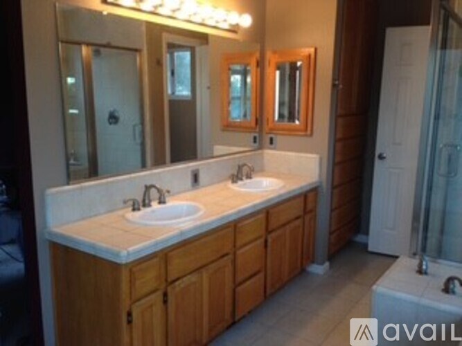 A bathroom with a vanity and a mirror.