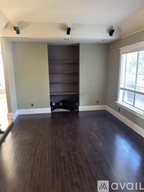 A room with wooden floors and a large closet.