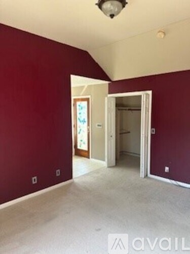 A room with red walls and a white door.