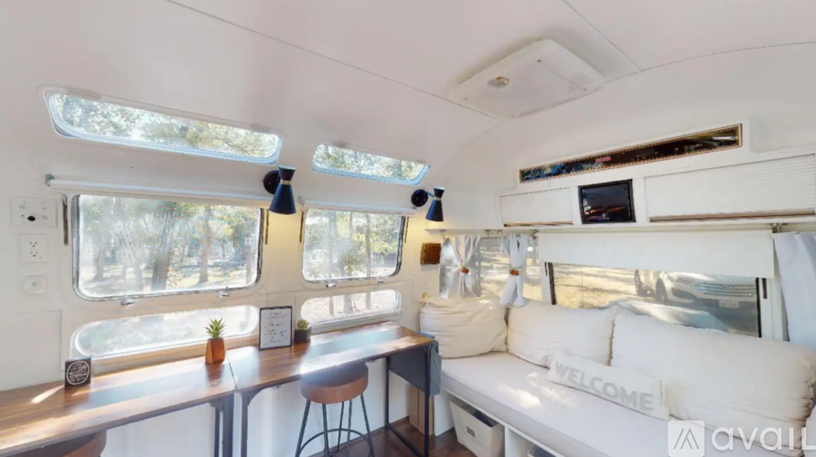 A white interior of a boat with a bar and a couch.