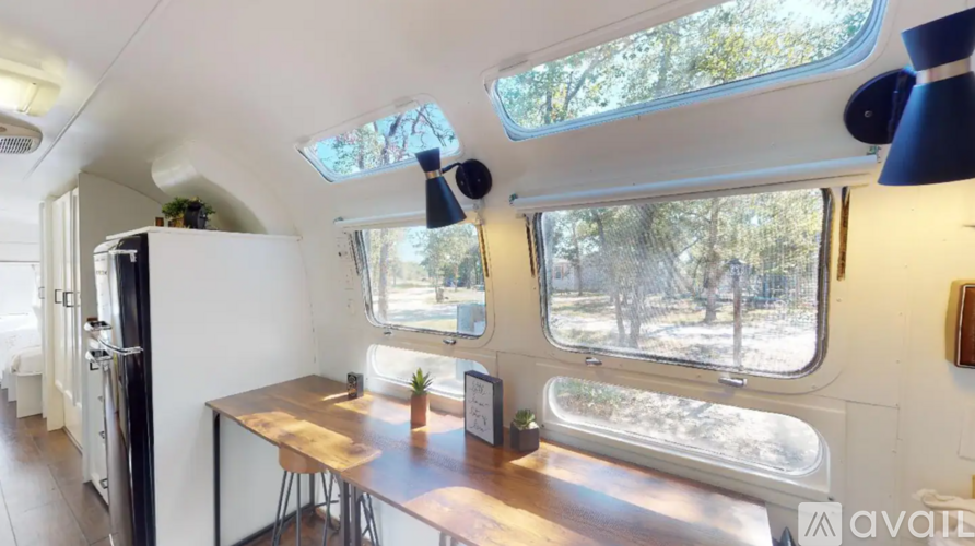 The interior of a camper van with a table and chairs.