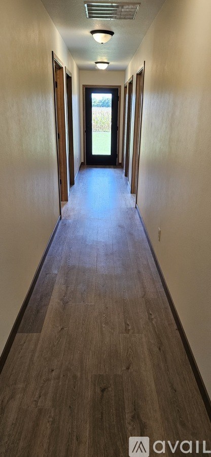 A long hallway with a door at the end.