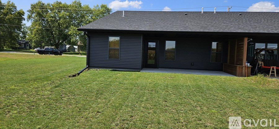 A house with a grey roof and a covered patio.