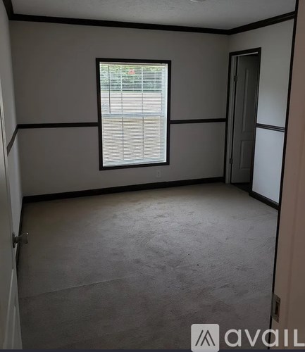 A room with a window and a door.