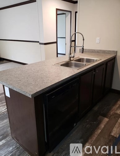 A kitchen with a sink and a window.