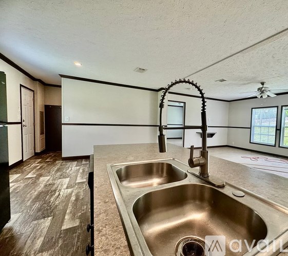 A kitchen with a sink and a window.
