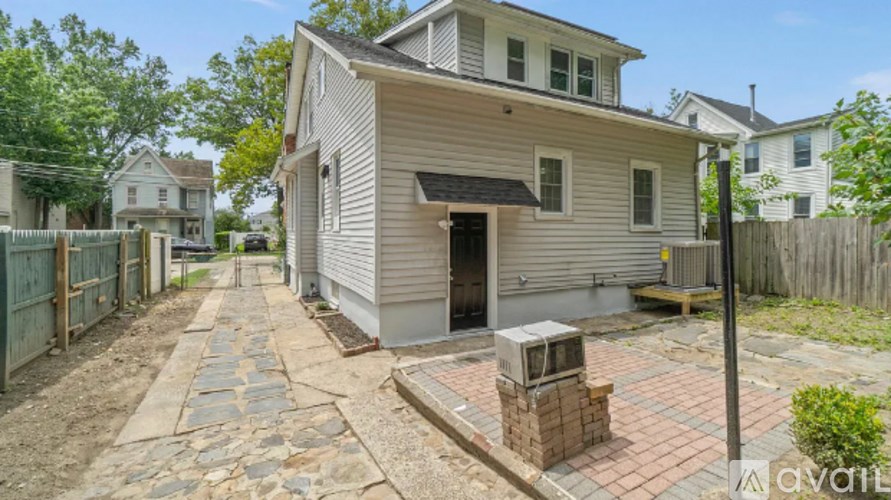 A house with a stone pathway leading to the front door.