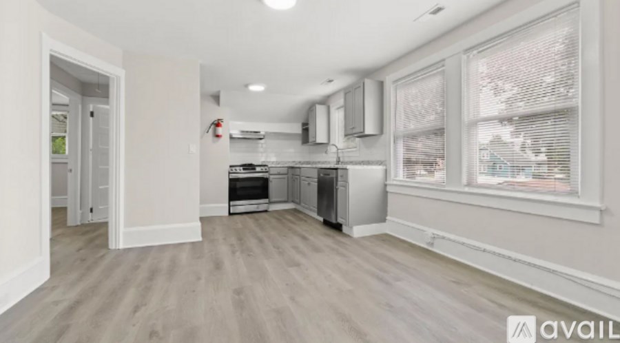 A kitchen area with a stove top oven and a refrigerator.