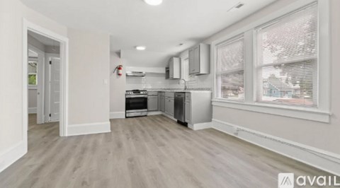 A kitchen area with a stove top oven and a refrigerator.