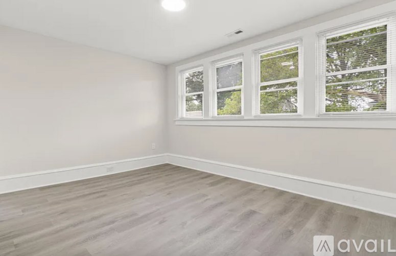 A room with a window and wooden flooring.