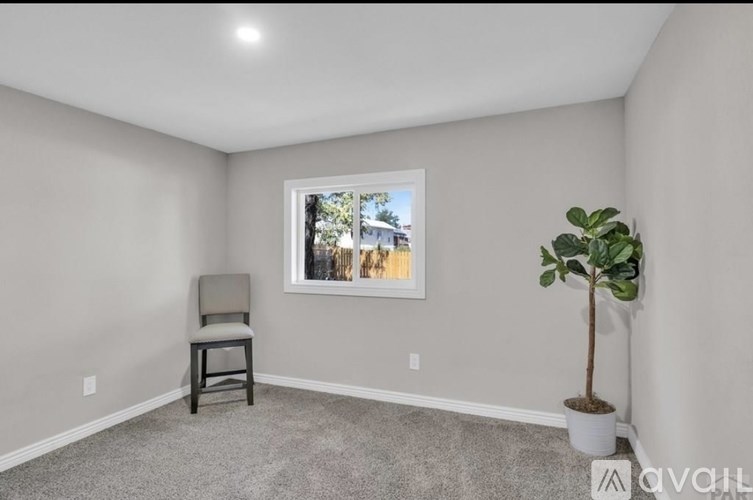 A bathroom with a white tub, toilet, and sink.