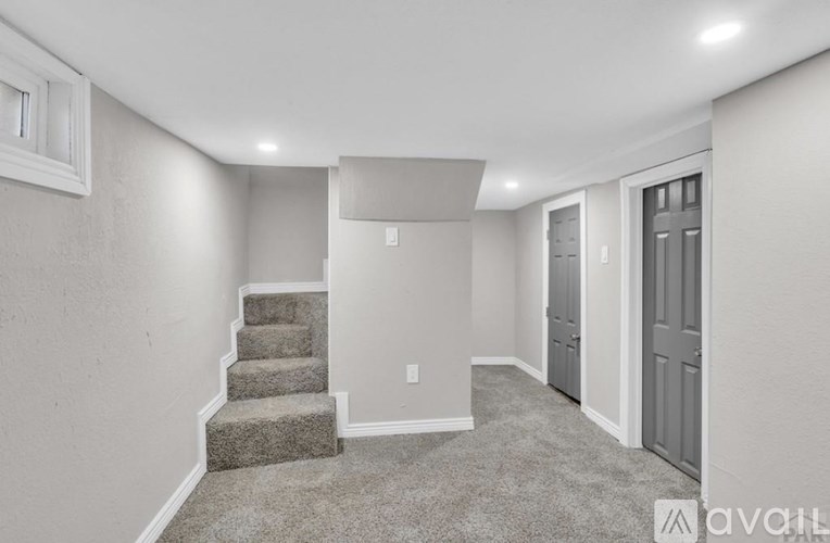 A room with a staircase and a door.