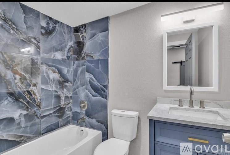 A bedroom with a bed, a wardrobe, and a carpeted floor.