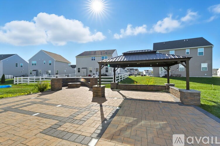 A sunny day at a residential area with a pavilion and a fence.