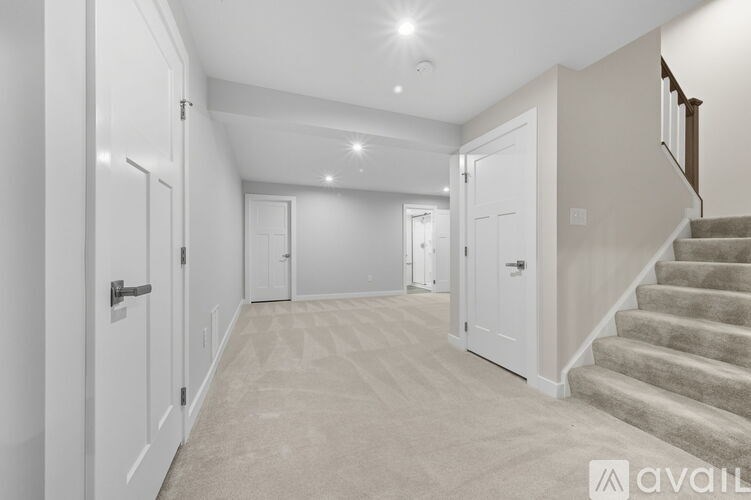 A spacious hallway with a staircase leading to the second floor.