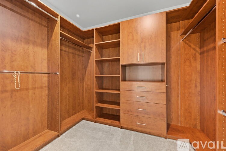 A large wooden wardrobe with drawers and shelves.