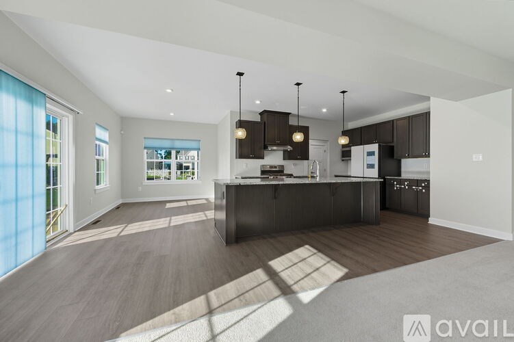 A modern kitchen with dark wood cabinets and a central island.