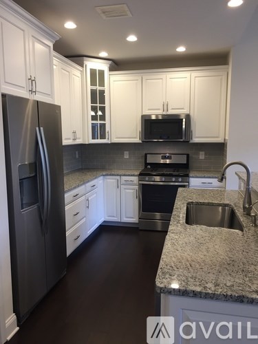 A kitchen with granite countertops and stainless steel appliances.