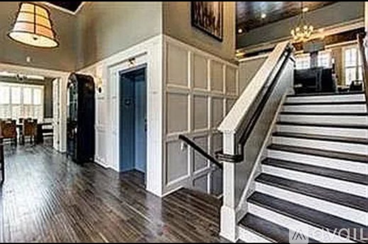 A staircase with a black and white striped runner.