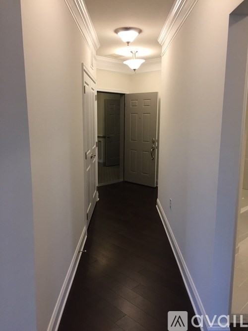 A long hallway with a door at the end.