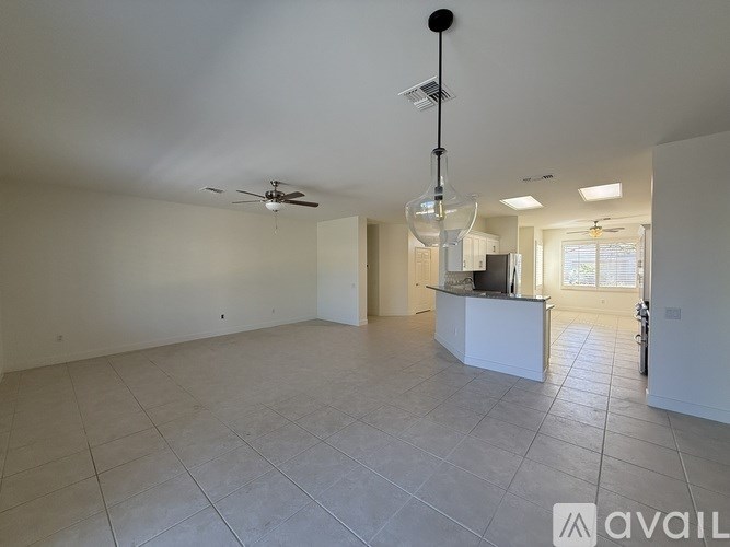 A kitchen with white cabinets and a stainless steel refrigerator.
