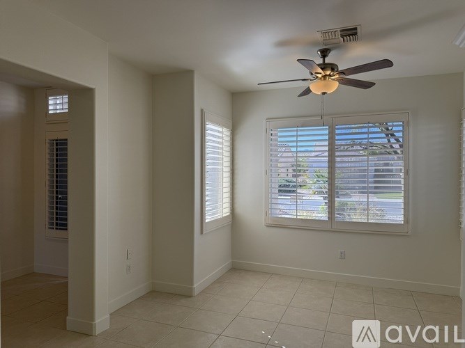A dining room with a table and chairs.