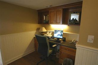 a small office with a desk and a computer
