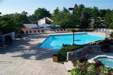 a large swimming pool with chairs around it