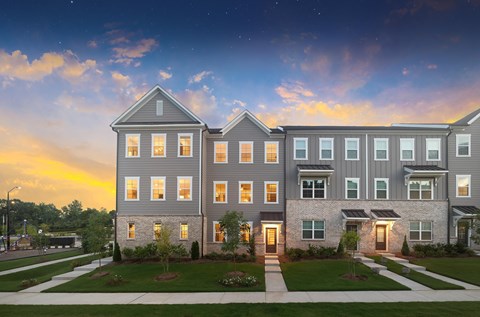 A modern apartment complex with multiple buildings and well-maintained lawns.