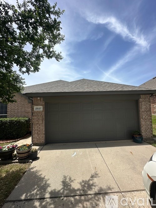 A house with a garage and a driveway.