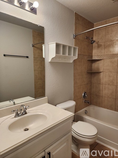A bathroom with a sink, toilet, and bathtub.