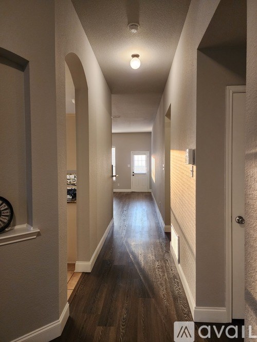 A long hallway with a light at the end.