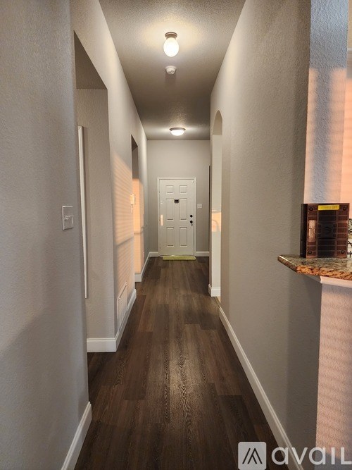 A long hallway with a door at the end.