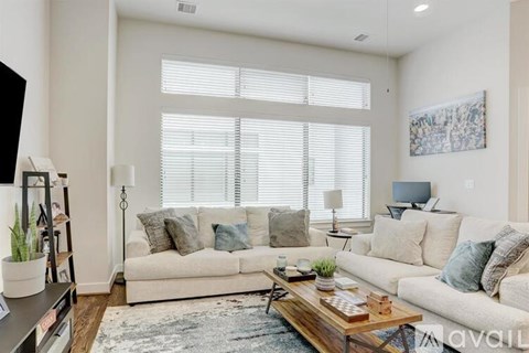 A living room with a white couch and a coffee table.