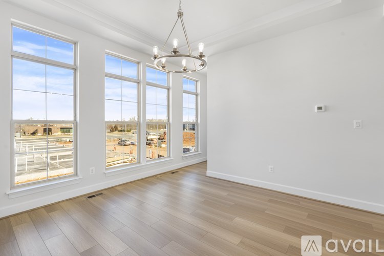 A large empty room with a view of the city through the windows.