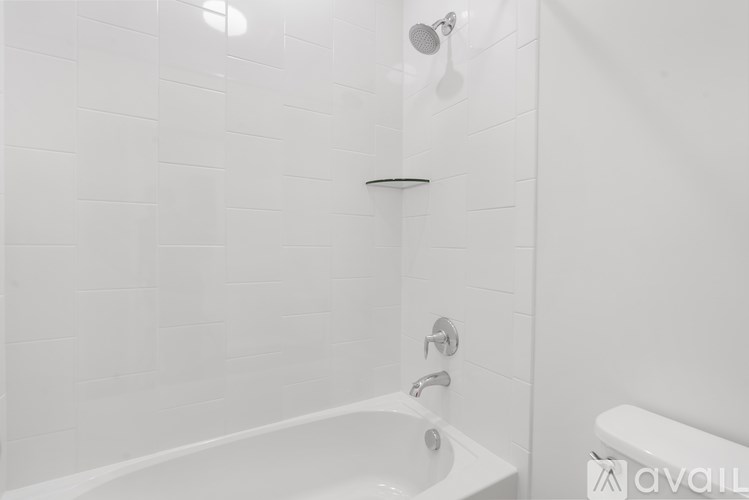 A white bathroom with a tub and shower.