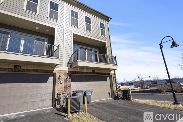 A two-story apartment building with a balcony on the second floor.