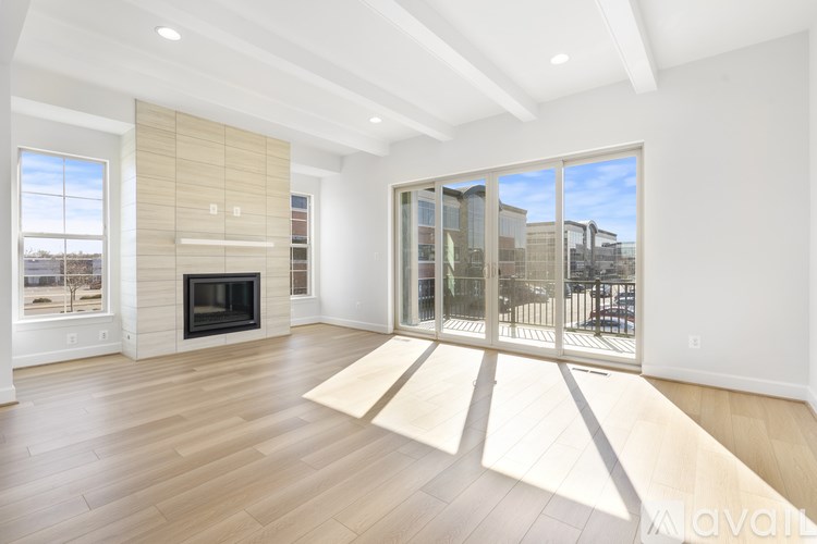 A spacious living room with a fireplace and sliding glass doors.