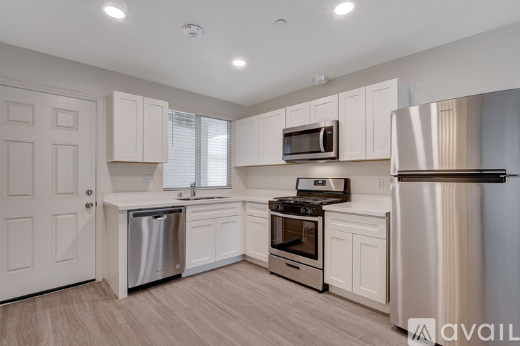 A kitchen with white cabinets and stainless steel appliances.