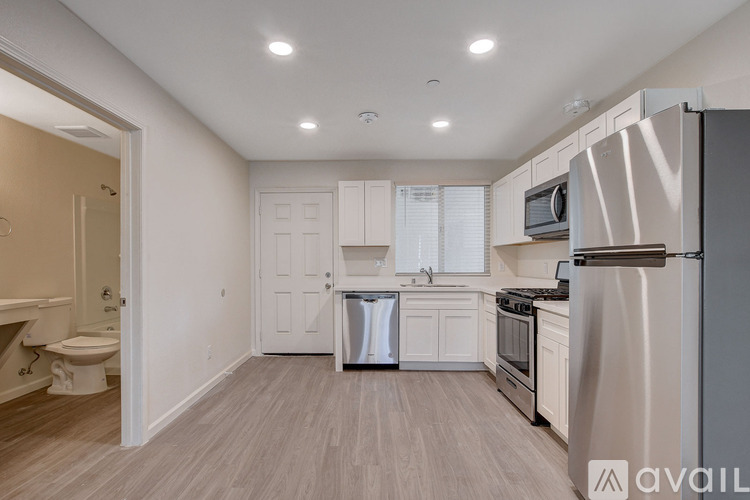 A kitchen with white cabinets and stainless steel appliances.