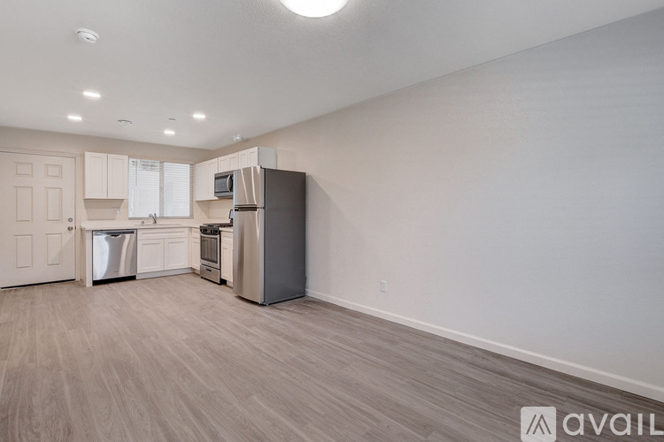 A kitchen with a refrigerator, oven, and dishwasher.