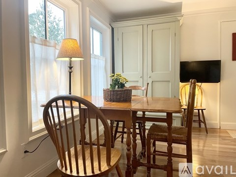 A kitchen with white cabinets and a red lantern hanging on the wall.