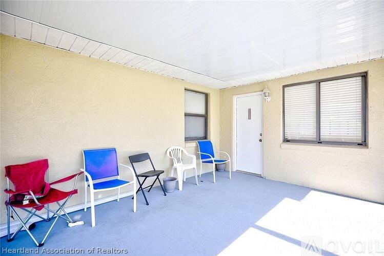 A row of chairs are lined up in a sunny room.