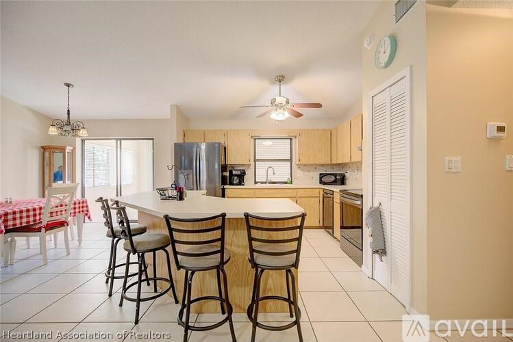 A kitchen with a table and chairs set up for dining.