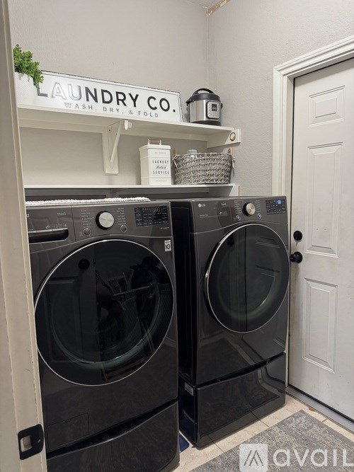 Two front loading washing machines in a laundry room.