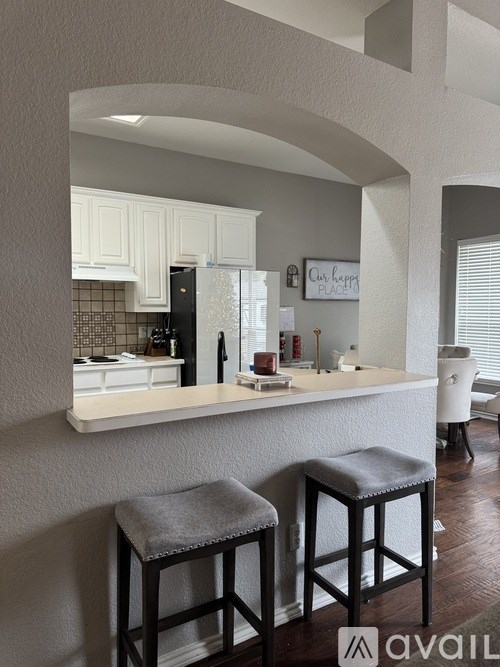 Two bar stools are in front of a kitchen island.