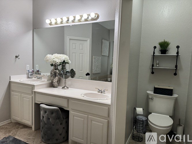 A white bathroom with a vanity and a toilet.