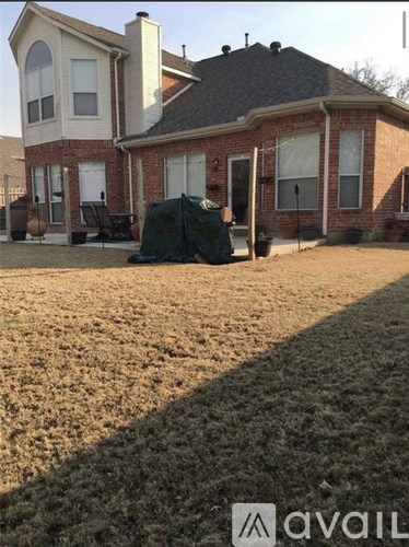 A house with a lawn in front of it.