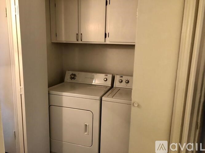 A small laundry room with a washer and dryer.