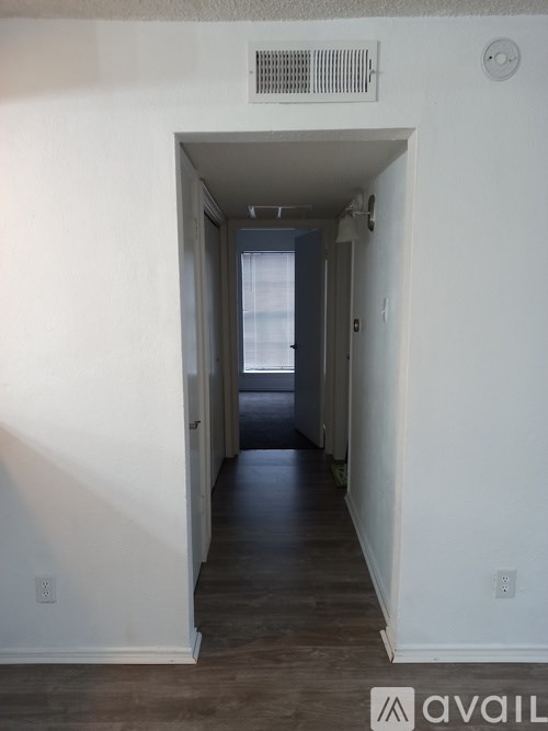 A long hallway with a door at the end.